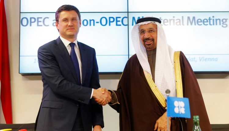 Russia’s Energy Minister Novakand Saudi Arabia’s Energy Minister al-Falih shake hands after a news conference following a meeting in Vienna